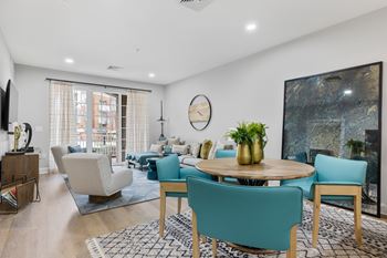 Open concept living and dining room with teal accents